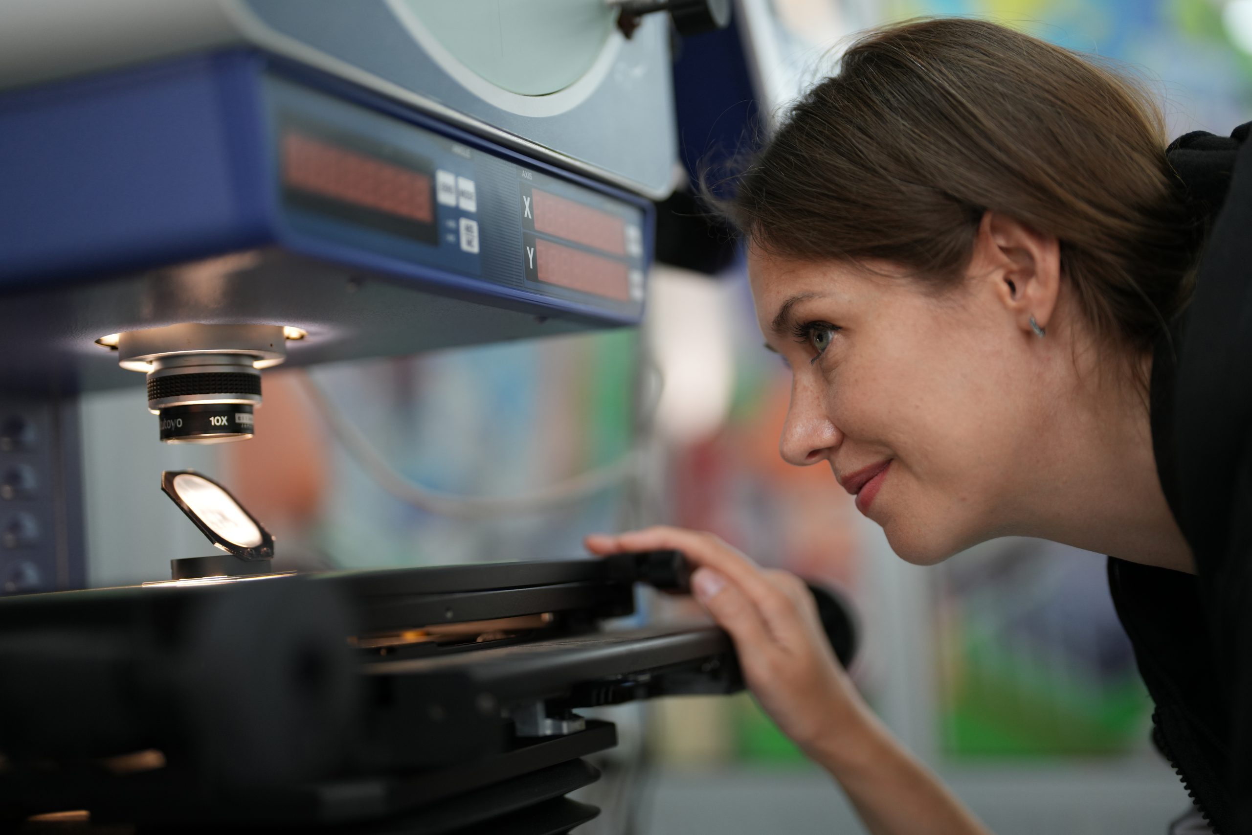 female-technician-programs-a-robot-arm-with-a-digi-2025-02-03-10-11-33-utc